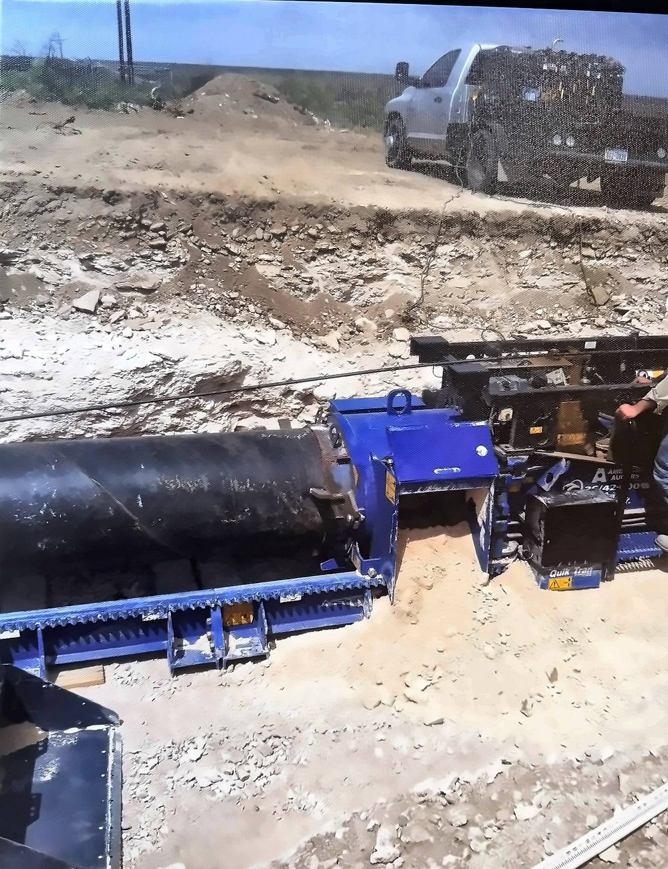 Auger boring equipment aligned with steel pipe for an underground crossing
